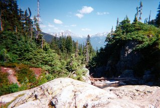At the lake, looking back at the trail and the start of a small waterfall seen from below, Rainbow Lake 1997-08.